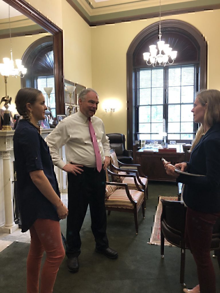 Jennifer Barnhill having a conversation with Senator Tim Kaine about military family advocacy.