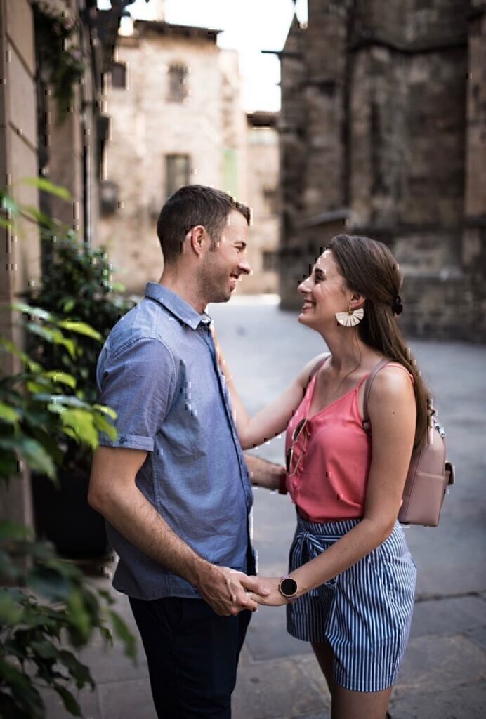 A women and her husband looking into each others eyes on an empty street.