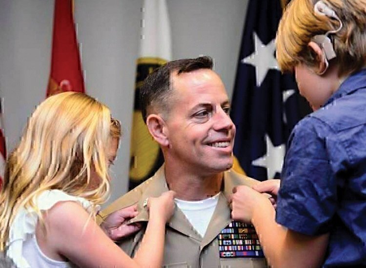 Haper and her sister, helping their father put his uniform on. 
