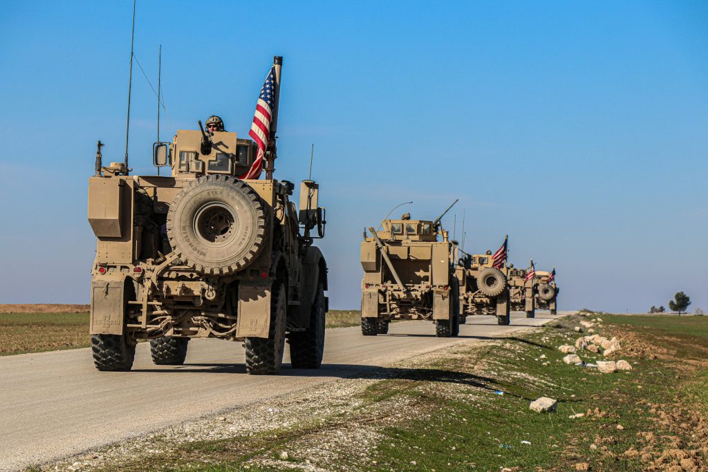 Military vehicles on desert road near Fort Irwin